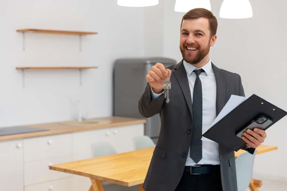 Male real estate agent holding key